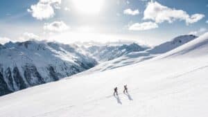 Snow-covered Rocky Mountain peaks near Banff in winter with ski slopes and pine forest